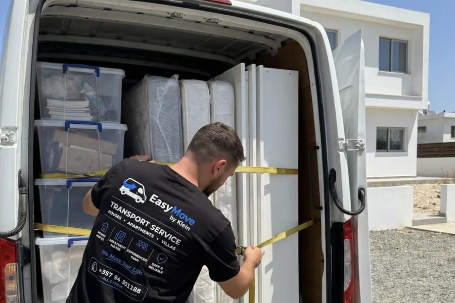 EasyMove by Klein mover strapping boxes and mattresses inside a van in Cyprus